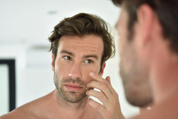 Man touching his face